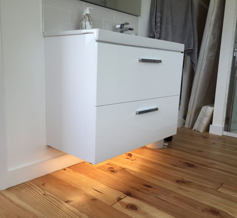 Under cabinet lighting controlled by motion sensor